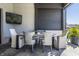 Charming outdoor dining space with a table, comfortable seating, and a mounted television for entertainment at 10937 Pete Dye Rdg, Zionsville, IN 46077