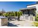 Outdoor kitchen with a built-in grill, ample counter space, and a cozy seating area for entertaining guests at 10937 Pete Dye Rdg, Zionsville, IN 46077