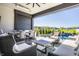 Expansive outdoor living area with a dining table, lounge chairs, lush landscaping, and inviting pool at 10937 Pete Dye Rdg, Zionsville, IN 46077