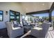 Inviting outdoor seating area with comfortable chairs, a fireplace, and scenic views of the surrounding landscape at 10937 Pete Dye Rdg, Zionsville, IN 46077