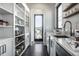 Bright pantry with custom shelving, cabinets, and a countertop with a sink at 10937 Pete Dye Rdg, Zionsville, IN 46077