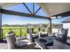 Covered patio boasting comfortable seating, a fire pit table, and scenic views of the community at 10937 Pete Dye Rdg, Zionsville, IN 46077
