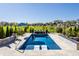 Luxurious pool area with crystal-clear water, in-pool loungers, and beautifully landscaped surroundings at 10937 Pete Dye Rdg, Zionsville, IN 46077