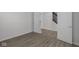 Bedroom featuring vinyl flooring, neutral paint and a double door entrance to the hallway at 9959 Redwood Peak Ln, Indianapolis, IN 46259