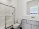 Bathroom with shower stall, sink, grey vanity, large mirror, and dark wood floor at 7856 Magnolia St, New Palestine, IN 46163