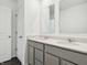 Bright bathroom featuring a double sink vanity with gray cabinets and white countertop at 7856 Magnolia St, New Palestine, IN 46163