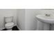 Half bathroom showcases a pedestal sink and white toilet at 7856 Magnolia St, New Palestine, IN 46163