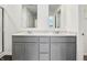 Bathroom with a double sink vanity, white quartz counters, and two mirrors at 7856 Magnolia St, New Palestine, IN 46163
