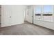 Bright bedroom with a view, featuring neutral carpet, white walls, and walk-in closet at 7856 Magnolia St, New Palestine, IN 46163