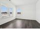 Bright bedroom with two windows and dark wood-look flooring at 7856 Magnolia St, New Palestine, IN 46163