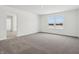 Bedroom featuring soft carpet, neutral walls, and natural light from the window at 7856 Magnolia St, New Palestine, IN 46163