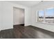 Bedroom features dark floors, natural light, and an adjacent room at 7856 Magnolia St, New Palestine, IN 46163