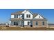 Charming new construction two-story home with brick accents and a well-lit front porch at 7856 Magnolia St, New Palestine, IN 46163