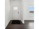 Bright foyer featuring hardwood floors, white walls, and a window for natural light at 7856 Magnolia St, New Palestine, IN 46163