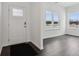 Bright entryway featuring hardwood floors, white walls, and natural light at 7856 Magnolia St, New Palestine, IN 46163