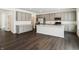 Modern kitchen with stainless steel appliances, gray cabinets, and an island at 7856 Magnolia St, New Palestine, IN 46163