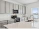 A well-lit kitchen features stainless steel appliances, a large island, and plenty of cabinet space at 7856 Magnolia St, New Palestine, IN 46163