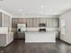 Modern kitchen with stainless steel appliances, gray cabinets, and a center island at 7856 Magnolia St, New Palestine, IN 46163