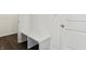 Mudroom features a built-in bench, wainscotting, and dark wood-look floors at 7856 Magnolia St, New Palestine, IN 46163