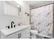 Bright bathroom featuring black hardware, stylish vanity and marble-patterned shower curtain at 2161 Napoleon St, Indianapolis, IN 46203