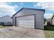 Gray detached garage with large white garage door and small window at 2161 Napoleon St, Indianapolis, IN 46203