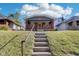 Brick steps leading to a charming gray house with a front porch at 2161 Napoleon St, Indianapolis, IN 46203