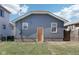 Gray detached garage with orange door in backyard at 2161 Napoleon St, Indianapolis, IN 46203