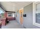 Covered porch with brick columns and an orange door at 2161 Napoleon St, Indianapolis, IN 46203