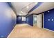 Spacious basement with blue walls, track lighting, and carpet at 4729 Pearcrest Way, Greenwood, IN 46143