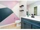 Modern bathroom with geometric patterned wall and dark vanity at 4729 Pearcrest Way, Greenwood, IN 46143