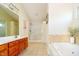 Main bathroom with double vanity, soaking tub, and glass shower at 4729 Pearcrest Way, Greenwood, IN 46143