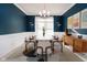 Elegant dining room with a modern table and blue walls at 4729 Pearcrest Way, Greenwood, IN 46143