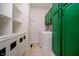 Functional laundry room with green cabinets and built-in shelving at 4729 Pearcrest Way, Greenwood, IN 46143