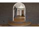 Arched doorway and step-up revealing stairs with view of decorative ceiling at 6470 Around The Hills Rd, Indianapolis, IN 46226