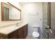 Bathroom featuring a stylish vanity, toilet, and glass block window at 6470 Around The Hills Rd, Indianapolis, IN 46226