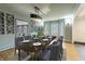 Elegant dining room featuring an expansive dining table, modern light fixture, and views through bay windows at 6470 Around The Hills Rd, Indianapolis, IN 46226