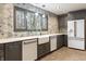 Charming kitchen featuring stainless steel appliances, custom cabinets, and decorative backsplash at 6470 Around The Hills Rd, Indianapolis, IN 46226