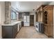 Well-lit kitchen with stainless steel appliances, custom cabinets, and a large window at 6470 Around The Hills Rd, Indianapolis, IN 46226