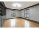 Bright room with hardwood floors, wainscoting, dark trim, built-in bookshelves, and windows at 6470 Around The Hills Rd, Indianapolis, IN 46226