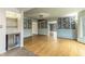Spacious living room with wet bar area, hardwood floors and access to another living space at 6470 Around The Hills Rd, Indianapolis, IN 46226