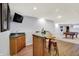 Finished basement with a wooden bar area, and billiards table in the distance at 3719 Carwinion Way, Carmel, IN 46032