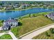 An aerial view of a lakefront property with a manicured lawn and stunning curb appeal in a lovely neighborhood at 1717 Beaufain St, Carmel, IN 46032