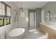 Bright bathroom with double sinks, soaking tub and glass-enclosed shower with dual shower heads at 1717 Beaufain St, Carmel, IN 46032