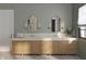 Elegant bathroom vanity with double sinks, stylish mirrors, sconces and herringbone flooring at 1717 Beaufain St, Carmel, IN 46032