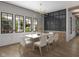 Elegant dining room with contemporary lighting, a wall of windows, and a stylish table setting at 1717 Beaufain St, Carmel, IN 46032