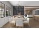 Bright dining room with stylish chandelier, modern decor, and adjacent living space at 1717 Beaufain St, Carmel, IN 46032