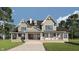 Charming two-story home with a covered porch, gray siding, and a welcoming entryway at 1717 Beaufain St, Carmel, IN 46032