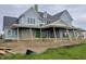 An exterior view of a new construction two-story home with light blue siding and a dark roof at 1717 Beaufain St, Carmel, IN 46032