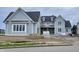 An exterior view of a new construction two-story home with light blue siding and a dark roof at 1717 Beaufain St, Carmel, IN 46032