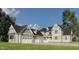 Stunning two-story home with a three-car garage, gray siding and a beautifully landscaped front yard at 1717 Beaufain St, Carmel, IN 46032